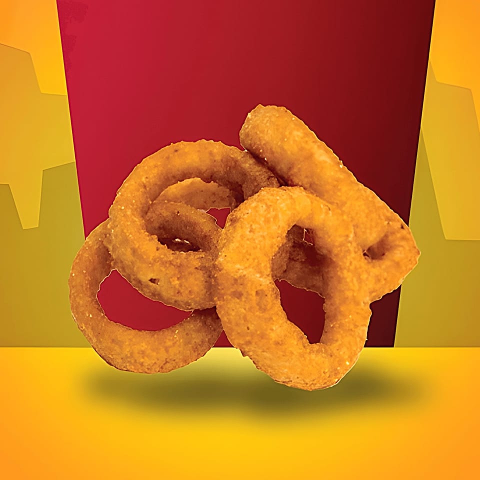 Golden-brown, crispy onion rings from Texas Burger Drive-In, against a red and yellow background.