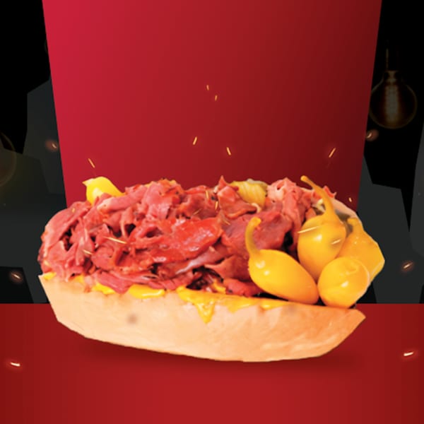 A Texas Burger Drive-In cheesesteak sandwich with yellow peppers on a red and black background.